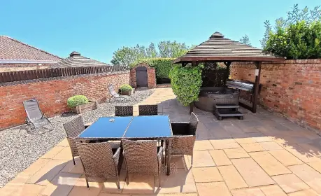 Stunning private courtyard with hot tub at Hawthorne Cottage, Mill Farm Leisure