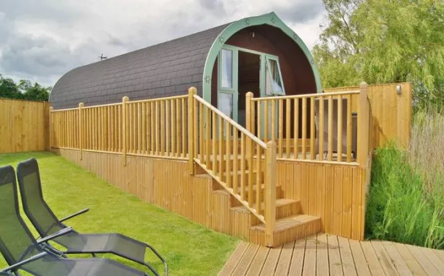Elm Lodge with dog friendly gardens, private hot tub on a large decked patio.